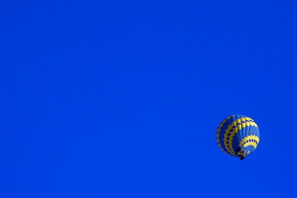 A balloon with a golden pattern on a blue sky