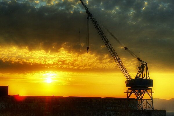 Crane at sunset in the clouds