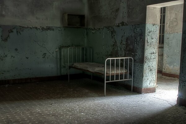 A lonely bed in an abandoned room