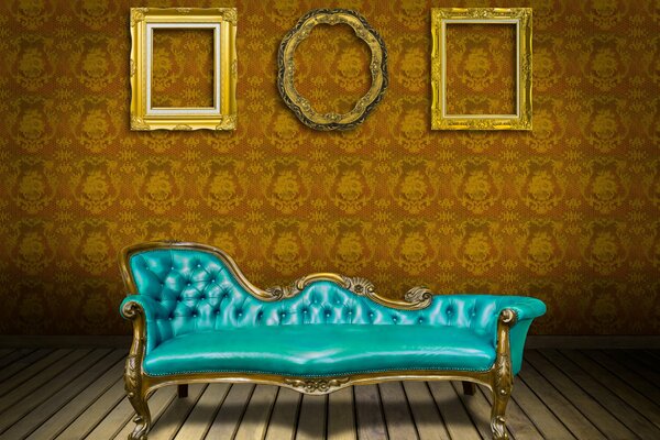 Blue sofa and frames without pictures on the wall