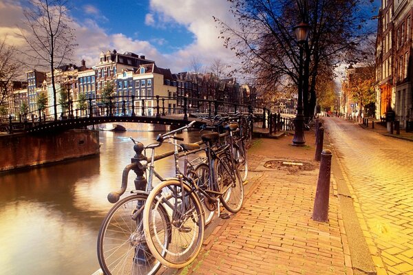 Amsterdam embankment with a bridge and parked bicycles