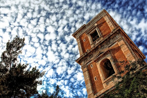 Tower against the sky and clouds