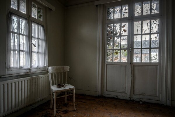 Window and door in a room with a chair