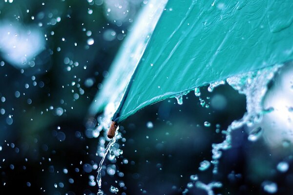 Краешек зонта, которого стекает дождевая вода