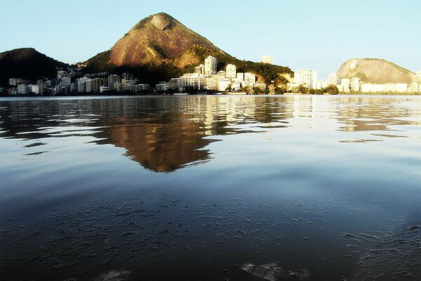 The city and the mountains reflected in the water