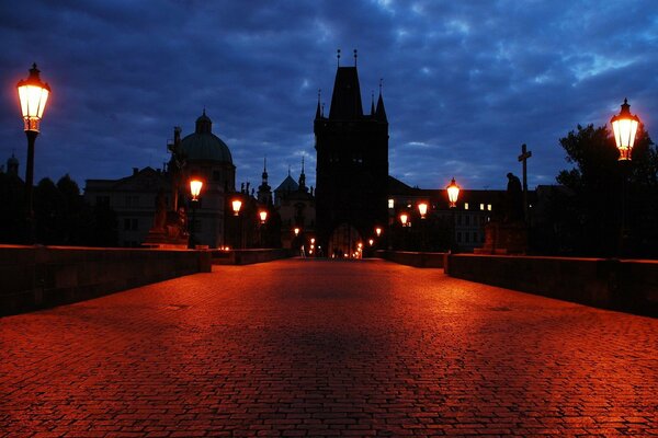 Evening lights over the bridge, red paving stones