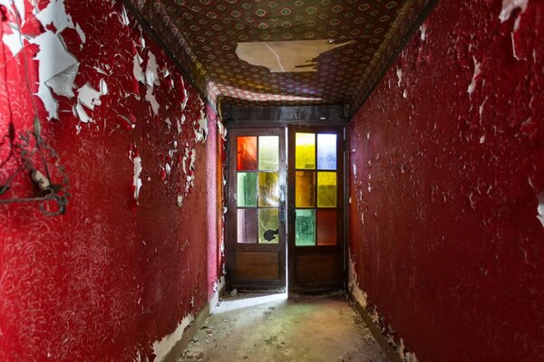 A corridor with shabby red walls