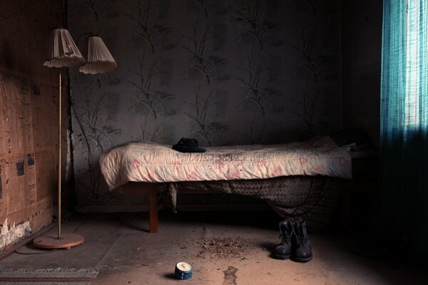 A dirty room with a lampshade and shoes