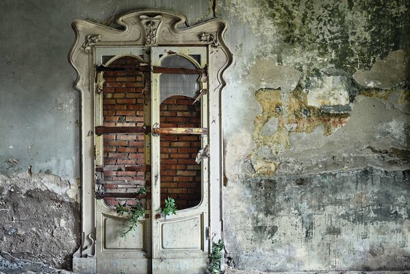 Hermosa puerta blanca con vidrio roto en un edificio abandonado