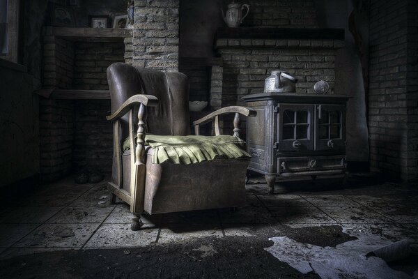 Пустое кресло и чайник в заброшенной комнате