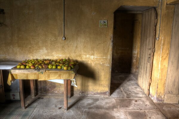 The table is littered with ripe apples