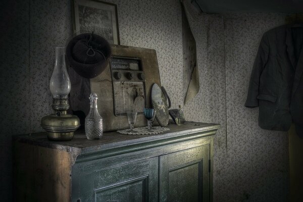 The radio is on the sideboard next to the lamp