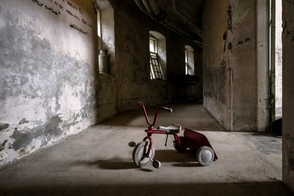 A bicycle in a room with old walls