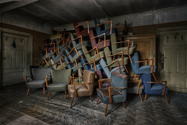 Lots of chairs in an abandoned room