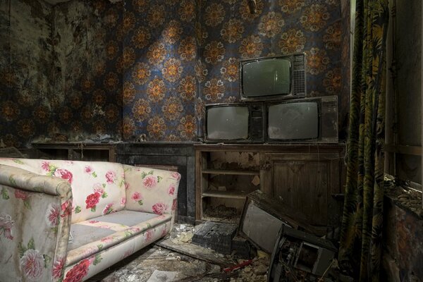 An old flowered sofa in an old room