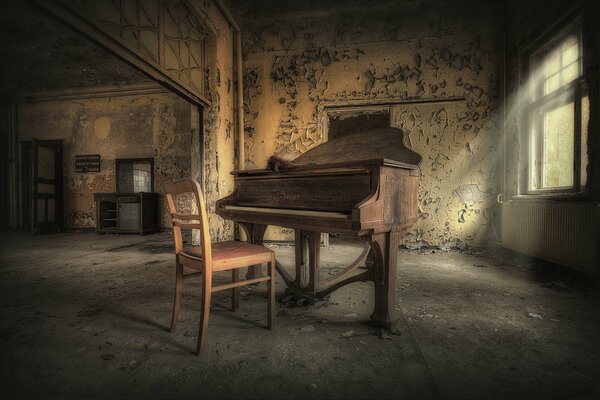 Piano and chair in an old room with one window