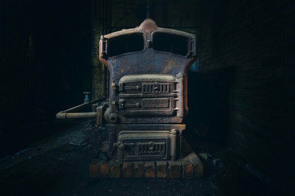 Brick oven with a pipe on the background of a dark room