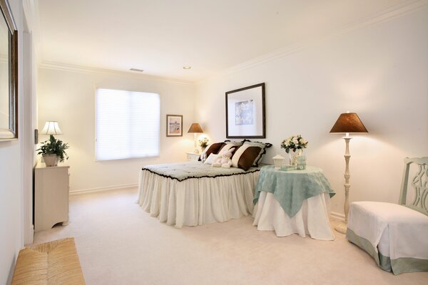 Image of a bed with a lamp on the table