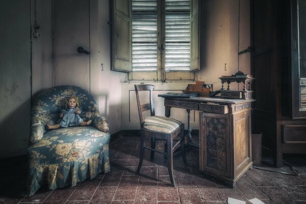 A room with a doll sitting in an armchair