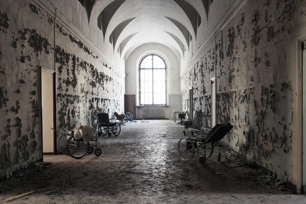 An abandoned hospital corridor with a window