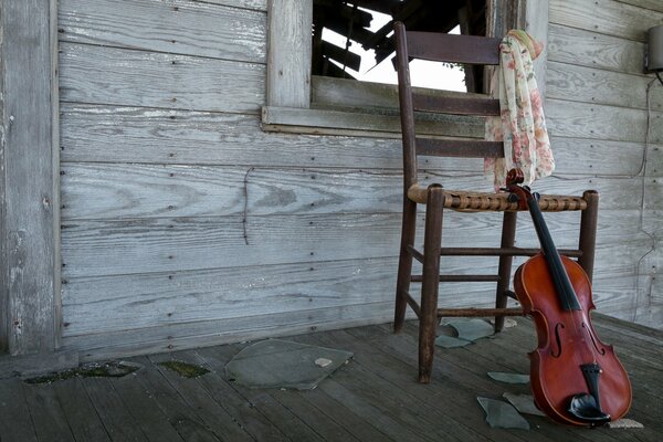 A violin in a house with broken glass