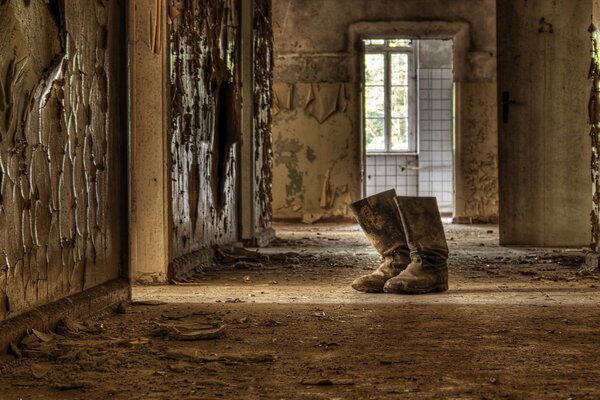 In an abandoned room. Boots in the hallway