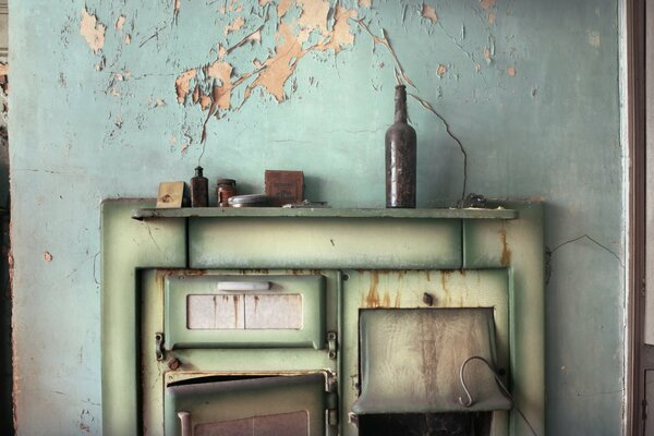 A bottle and a cabinet against a shabby wall