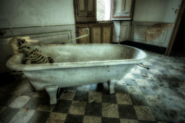 A skeleton in a bathtub against the shabby walls