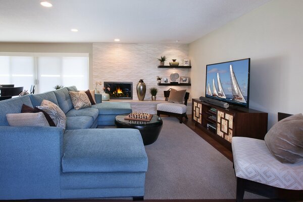 Stylish design of the living room with sofa, TV and fireplace