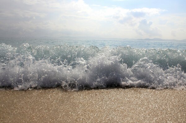 A wave of sea foam on the shore