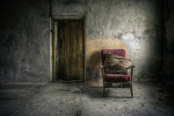 A chair in a damp, gray room