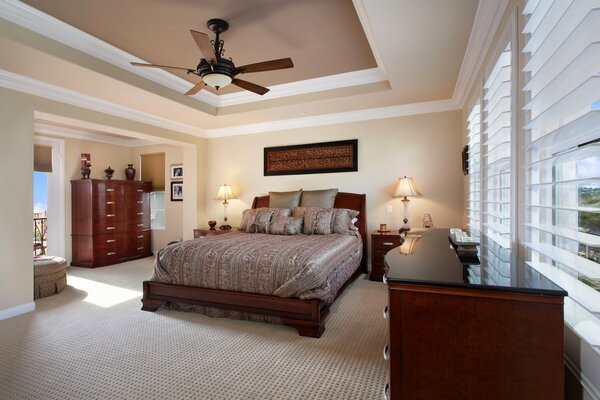 Modern design of the bedroom with a spacious bed