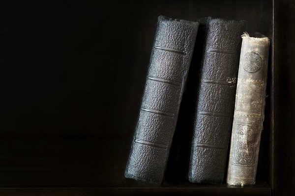 Old collectible books on a black background