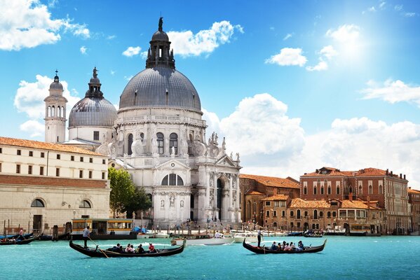 Architecture of the Italian cathedral on the background of gondolas