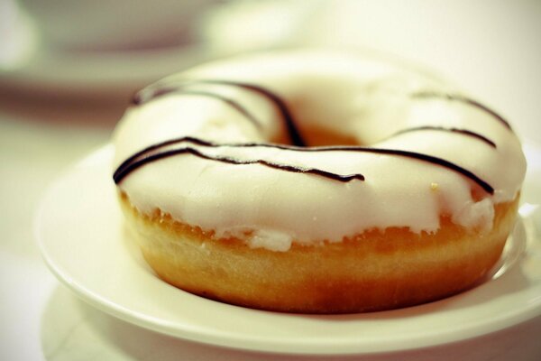 Donut on a plate with white icing