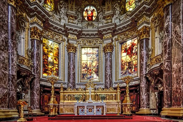 The altar in the cathedral. Old stained glass windows
