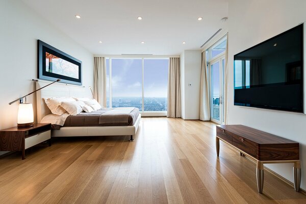 Minimalistyczne wnętrze sypialni z widokiem na morze
