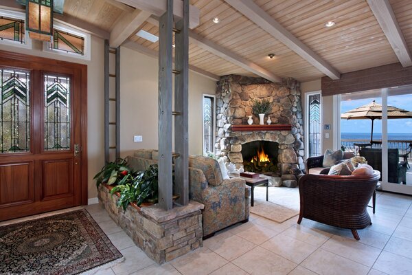 Interior of the living room with fireplace and floor-to-ceiling windows