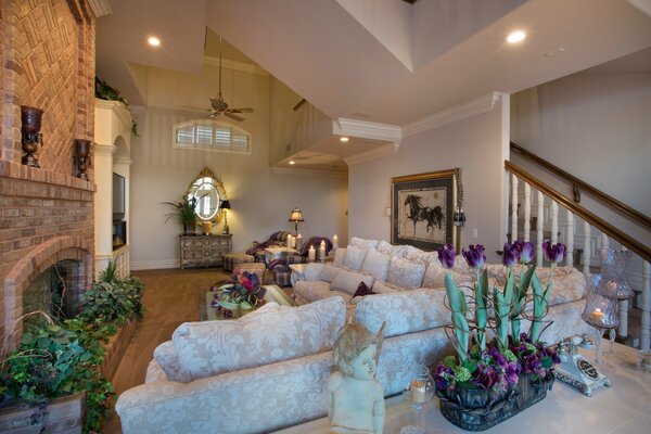 Large living room with fireplace and flowers