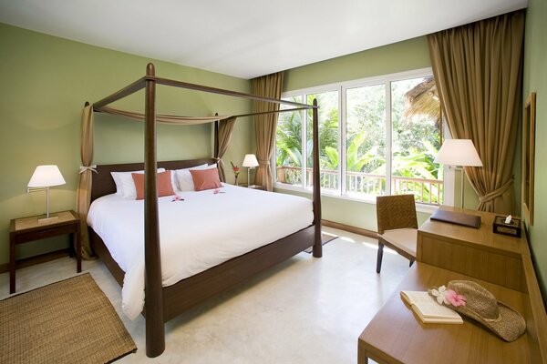 Double bed with pillows in a bright room