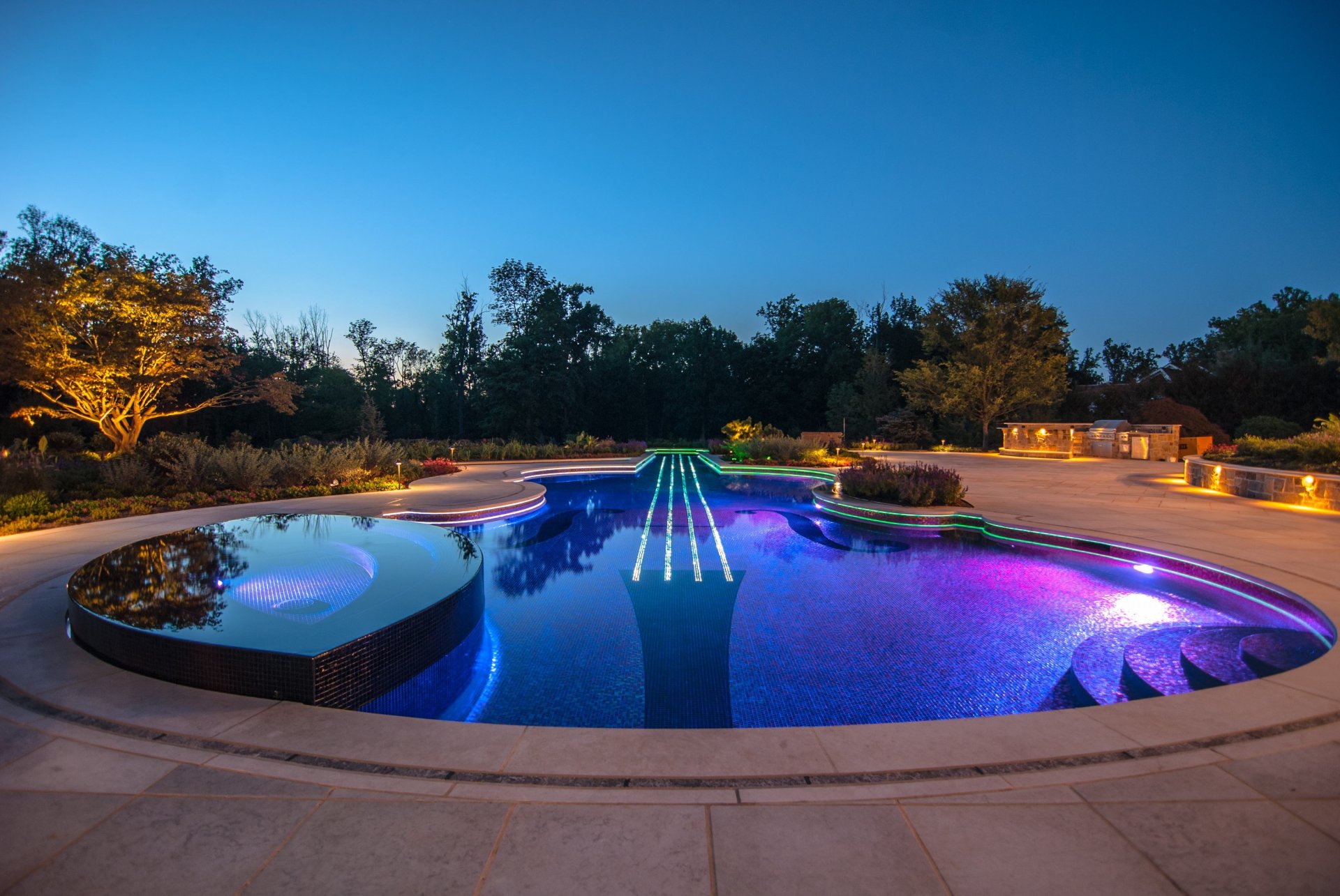 desigens pool jacuzzi trees evening