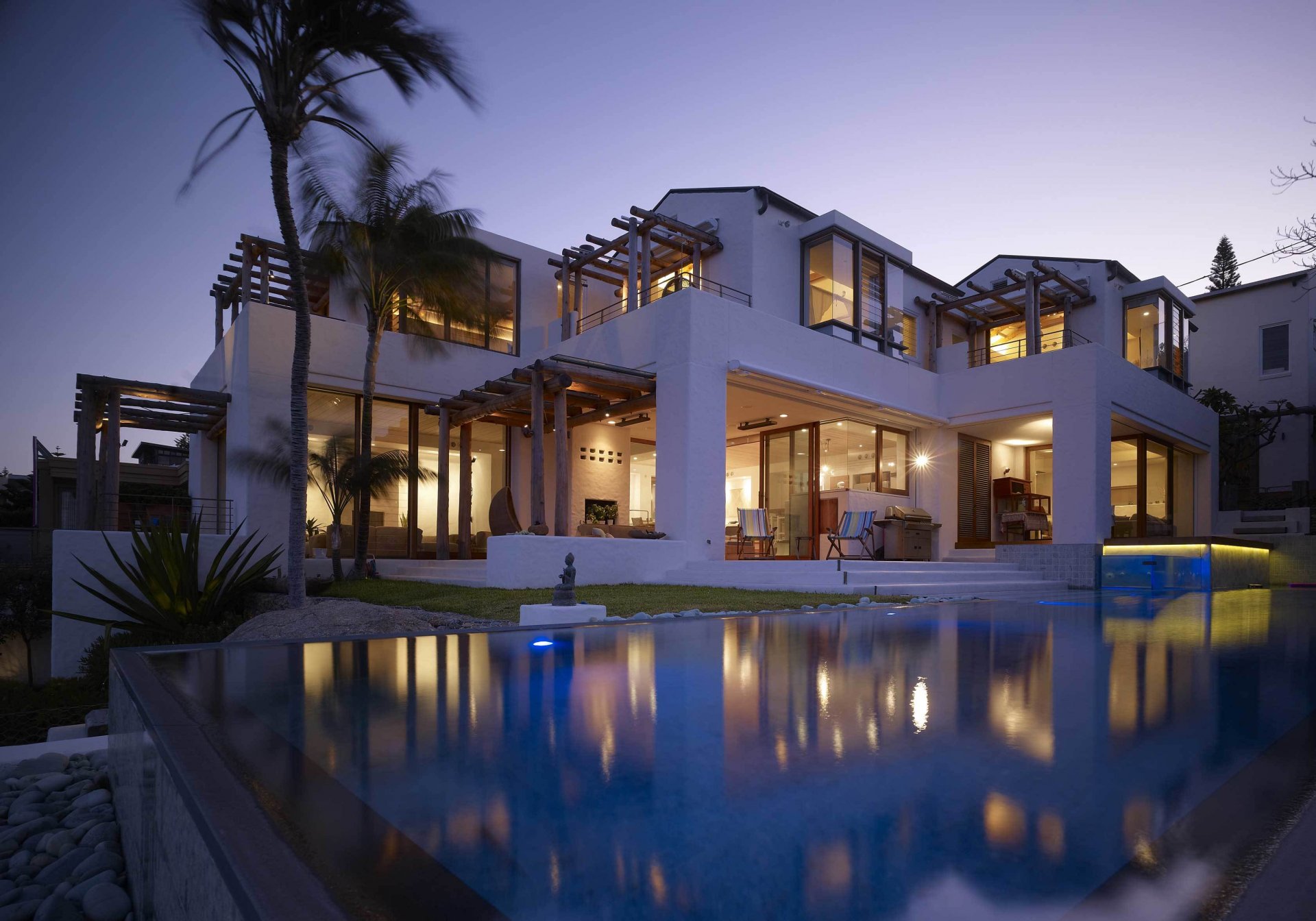 home house villa pool pools exterior exterior palm trees evening armchairs rooms furniture