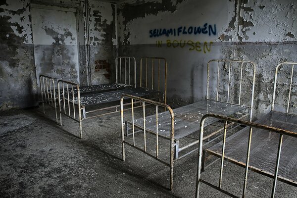 Stare łóżka w opuszczonej przestrzeni