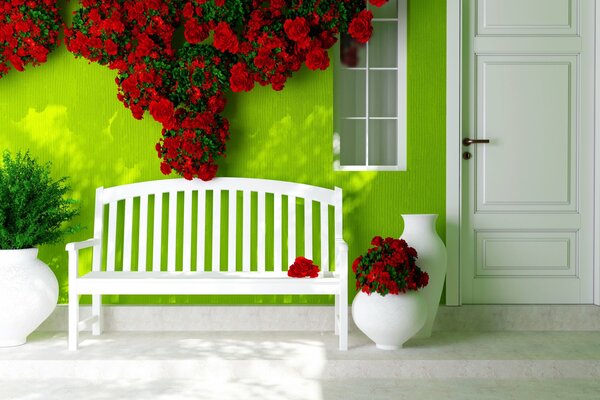 A bench by a green wall decorated with flowers