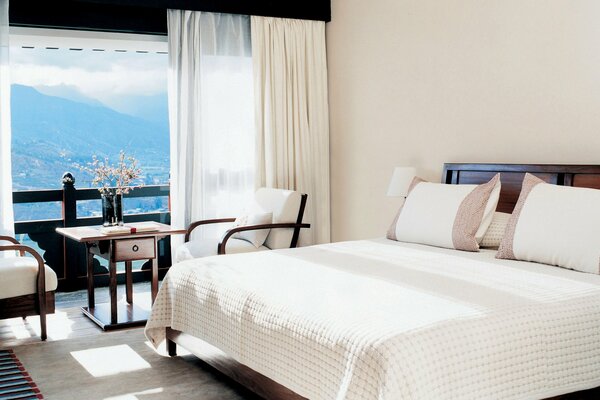 Bedroom in white with mountain view