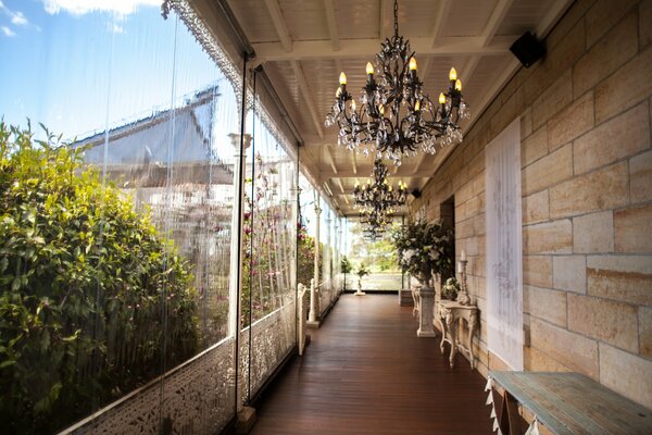 A luxurious balcony with elegant chandeliers and tables