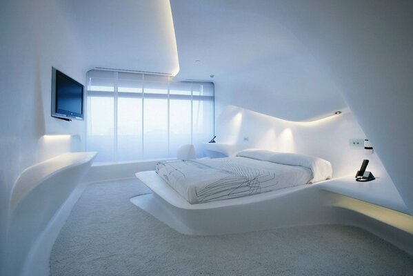 The interior of the room in white with a bed