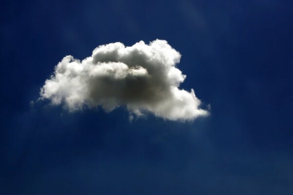 A light white cloud against the dark blue sky