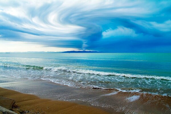 Clouds on the background of the beach and the sea