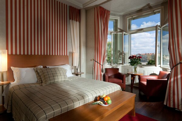 A hotel room in Prague with a window overlooking the city